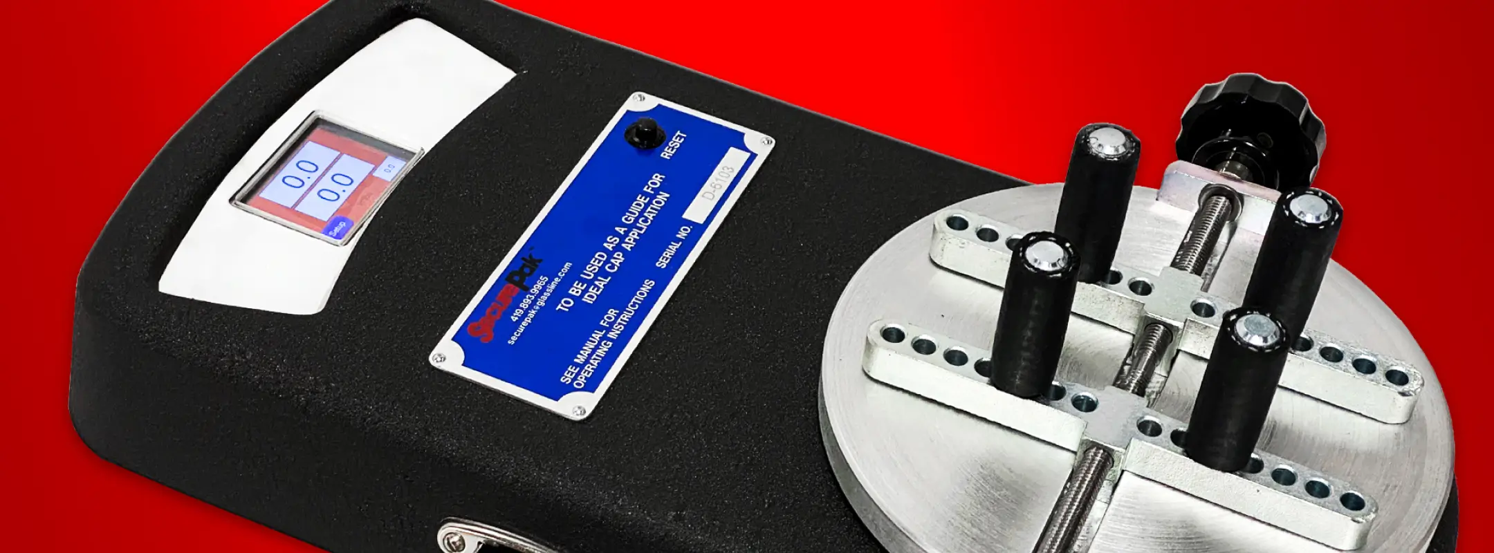 Close-up of SecurePak Digital Torque Tester display showing 0.0 inch-pounds reading with interchangeable chuck assemblies for different bottle cap sizes